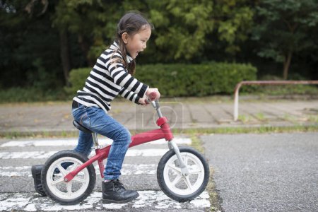 Photo for Little girl riding a bike - Royalty Free Image