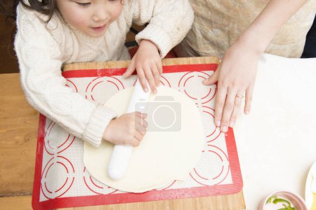 Photo for Mother and daughter making pizza - Royalty Free Image