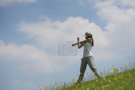 Photo for Woman on green hill lawn - Royalty Free Image