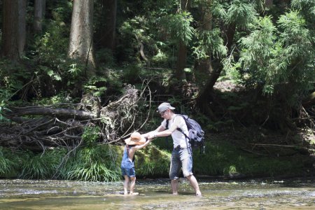 Téléchargez les photos : Père et enfant jouant dans la rivière - en image libre de droit