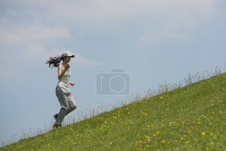 Woman on green hill lawn