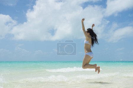 Foto de Hermosa mujer para saltar en la playa - Imagen libre de derechos