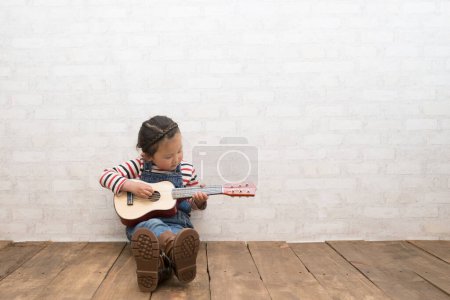 Photo for Girl to play the guitar - Royalty Free Image