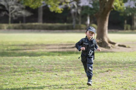 Photo for Happy Little Girl running in police costume - Royalty Free Image