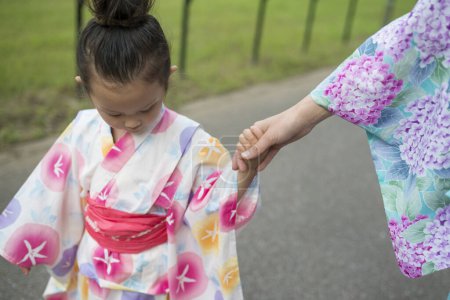 Photo for Holding Hands mother and daughter wearing yukata - Royalty Free Image