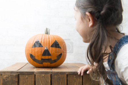Photo for Halloween pumpkin and Little Girl - Royalty Free Image