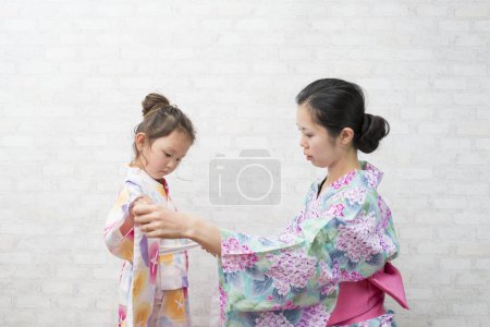 Photo for Mother and daughter to the dressing of yukata - Royalty Free Image