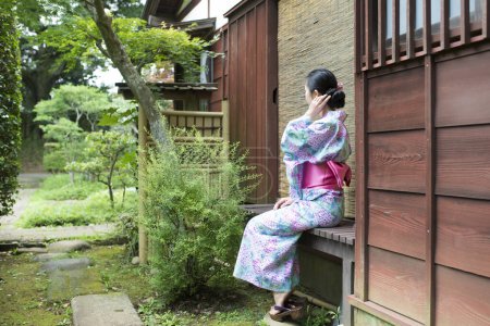 Photo for Woman sit wearing a yukata - Royalty Free Image