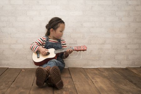 Photo for Girl to play the guitar - Royalty Free Image