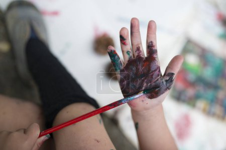 Photo for Little girl painting hand with color - Royalty Free Image