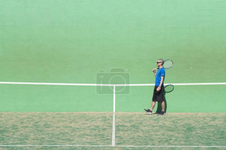 Man practicing tennis on court