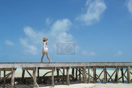Photo for Beautiful woman playing at the pier of the South Island - Royalty Free Image