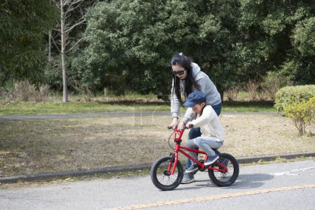 Téléchargez les photos : Mère et fille pratiquant le vélo - en image libre de droit