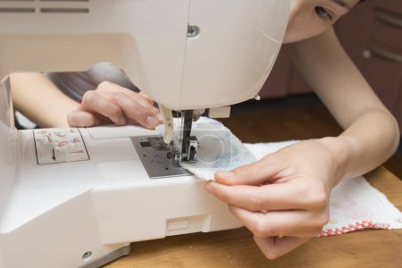 Photo for Woman use a sewing machine - Royalty Free Image