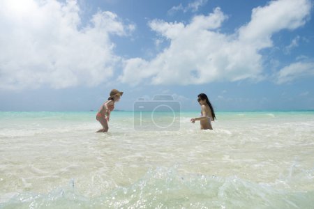 Photo for Mother and daughter playing on the beach - Royalty Free Image