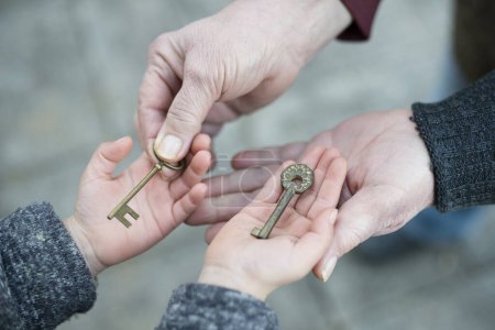 Grandma and granddaughter who hands with keys
