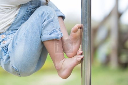 Happy little girl playing barefoot
