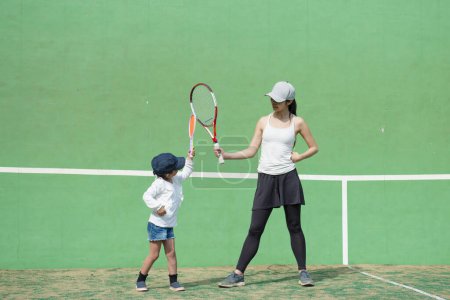 Mother and daughter playing tennis
