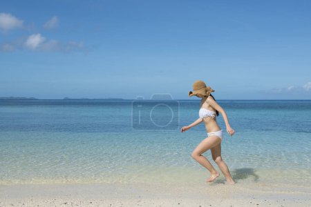 Photo for Woman relaxing on the beach - Royalty Free Image