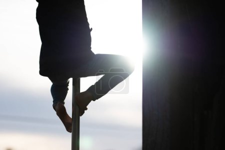 Photo for A child climbing a climbing pole - Royalty Free Image
