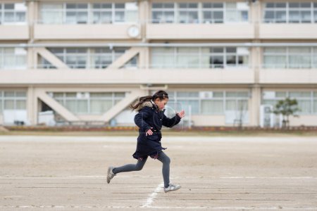 Photo for Girl running in the schoolyard - Royalty Free Image