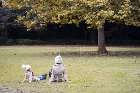 Photo for Mother and daughter playing in autumn park - Royalty Free Image