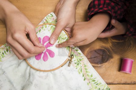 Photo for Woman hands making embroidery at table - Royalty Free Image