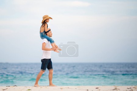 Photo for Father and daughter doing shoulders on the beach - Royalty Free Image