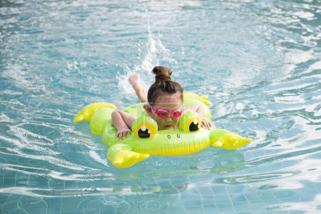 Téléchargez les photos : Mignonne petite fille asiatique dans piscine - en image libre de droit