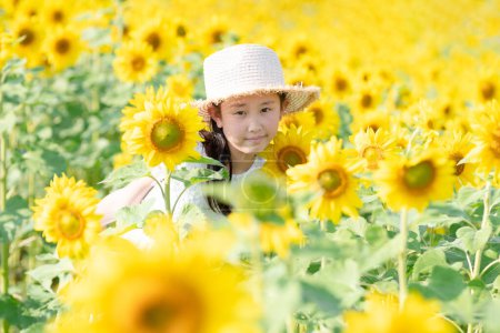 Photo for Beautiful asian little girl on  sunflower field in the morning - Royalty Free Image