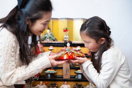 Photo for Little girl with mother with  chinese doll - Royalty Free Image