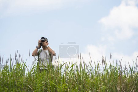 Photo for A man looking far away with binoculars - Royalty Free Image