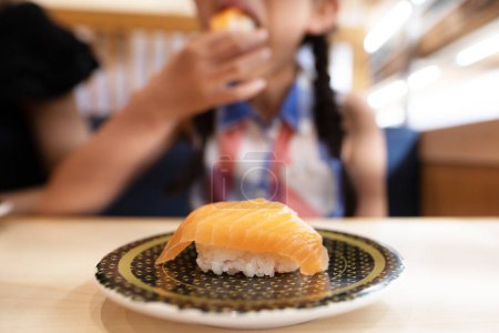 Photo for A child eating salmon sushi - Royalty Free Image
