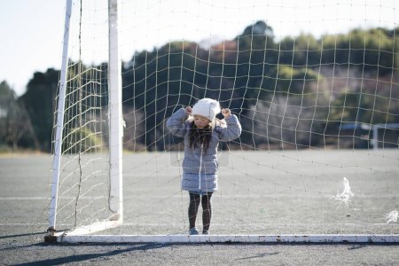 Photo for Little girl playing football field - Royalty Free Image