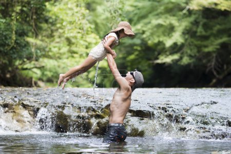 Photo for Father and daughter playing on mountain stream - Royalty Free Image