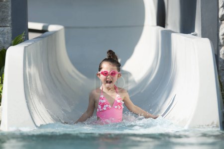 Photo for Little girl playing with a water slider - Royalty Free Image