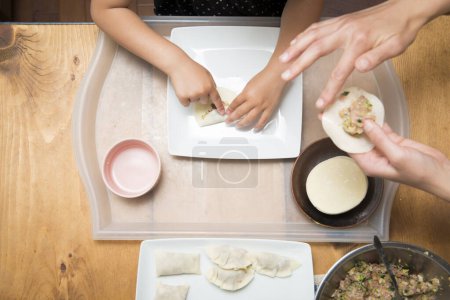 Photo for Mother and daughter making dumplings - Royalty Free Image