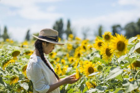 Sunflower field and beautiful woman
