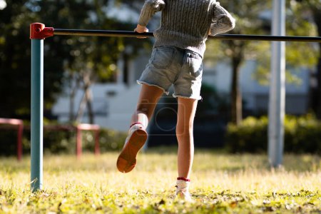 Photo for Child playing the horizontal bar - Royalty Free Image