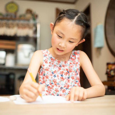 Photo for Cute little asian girl    drawing on the table - Royalty Free Image
