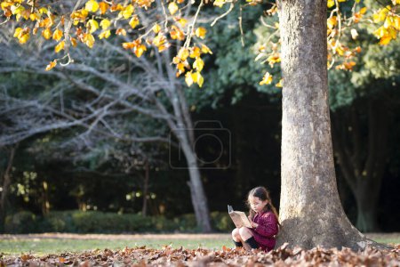 Photo for Little girl reading a book - Royalty Free Image