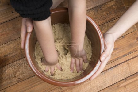 Photo for Parent and child hands making rice bran - Royalty Free Image