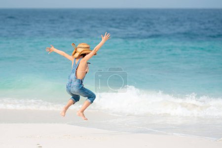 Téléchargez les photos : Mignonne asiatique petite fille sur la plage avec la mer - en image libre de droit