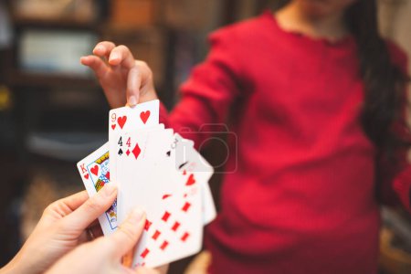 Photo for Mother and daughter playing card games at home - Royalty Free Image