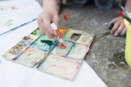 Photo for Little girl playing with paint - Royalty Free Image