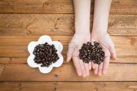 Parent and child hand with coffee beans