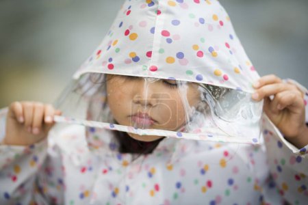 Photo for Little girl in rain coat outdoors - Royalty Free Image