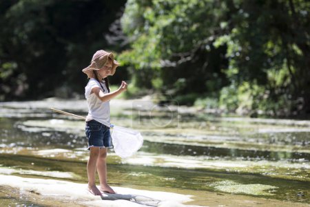 Photo for Happy Little Girl playing in the river - Royalty Free Image