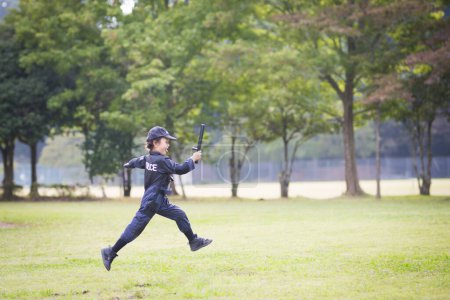 Photo for Little girl running in police costume - Royalty Free Image