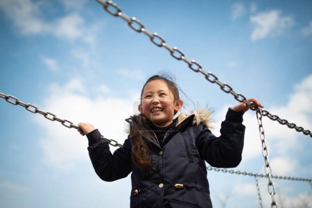 Photo for Happy girl playing on playground - Royalty Free Image